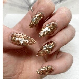example of gold glitter nails by brogan lee from bees beauty bar