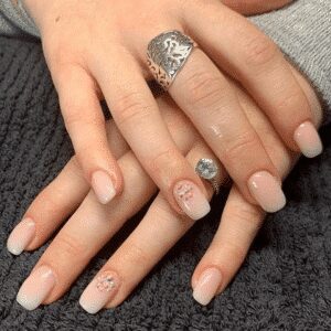 light pink nails with embellishments by brogan lee from bees beauty bar